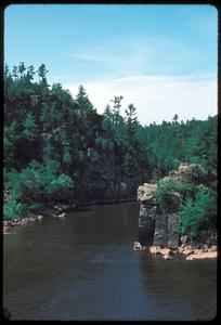 View of a river with cliffs in a northern forest
