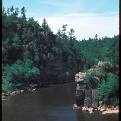 View of a river with cliffs in a northern forest