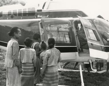 Villagers in a White Lahu village meet the USAID helicopter in Houa Khong Province