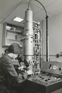 Woman at electron microscope