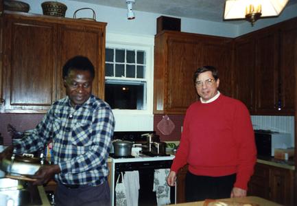 Folarin cooking with Dick Ammann