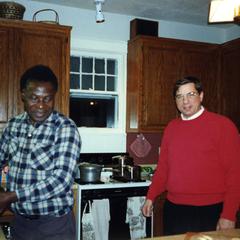 Folarin cooking with Dick Ammann