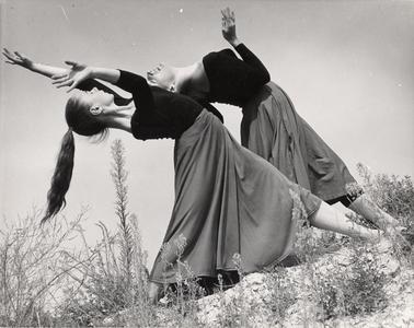 Women dancing on a hillside