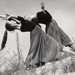 Women dancing on a hillside