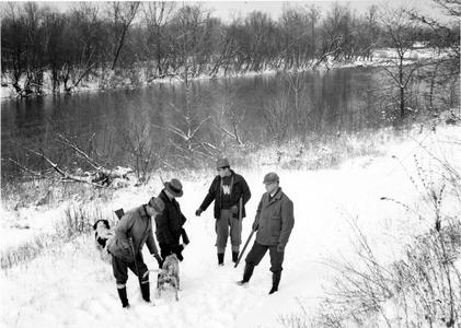 Ray Roark, Aldo Leopold, Luna, and George Bryan hunting at the Ozark Cabin