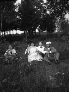 Carl Leopold, Sr., Clara Leopold, and two others seated in a field