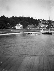 View of canoe, boats, and shoreline from boardwalk