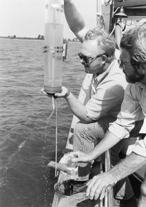 Professors Bud Harris and James Wiersma taking water samples