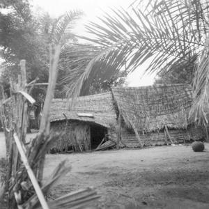 The Rear of Poorer Houses with Cassava Roots Drying on the Roof