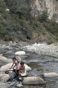 Local girls washing clothes in river, south of Finca La Cruz