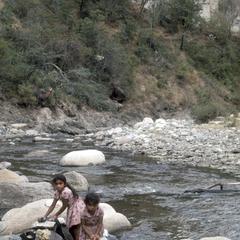 Local girls washing clothes in river, south of Finca La Cruz