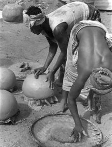 Women Forming Rounded Pots