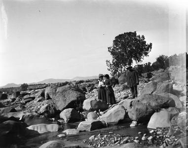 Man and two women standing on rocks