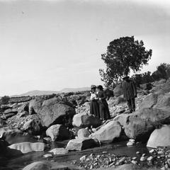 Man and two women standing on rocks