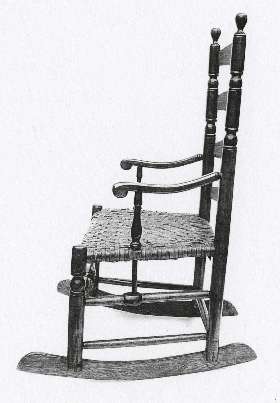Black and white photograph of a slat-back armchair with rockers.