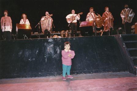 Child standing in front of the stage