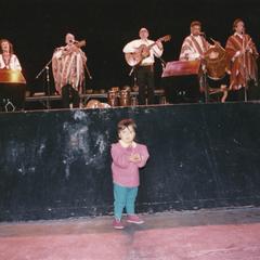 Child standing in front of the stage