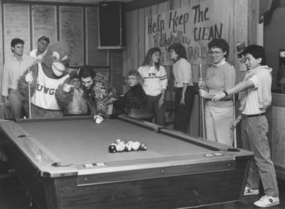 Students with Phoenix mascot playing pool in the student union's Rathskeller