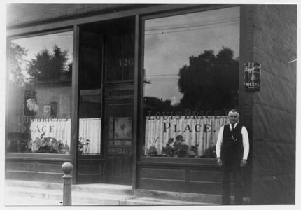 Louis Brice in front of his tavern