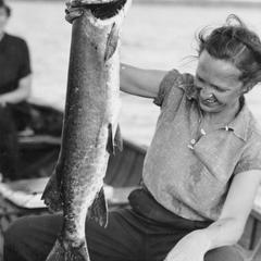Wisconsin Conservation Department photographer Dorothy Ferguson with musky