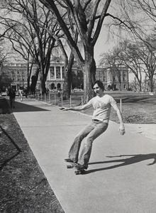 Student skateboarding down Bascom Hill