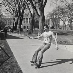 Student skateboarding down Bascom Hill