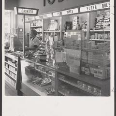 A saleswoman works at a tobacco counter in a drugstore