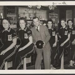 A women's drugstore bowling team poses for a group photo