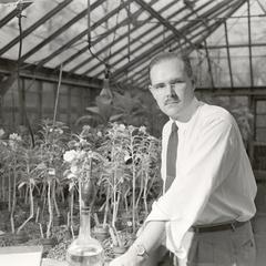 John T. Curtis in greenhouse