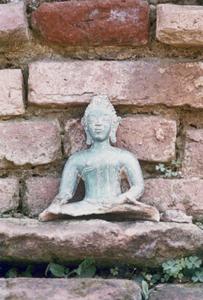 Ancient Buddhist bronze figurine near the village of Chommok in Houa Khong Province