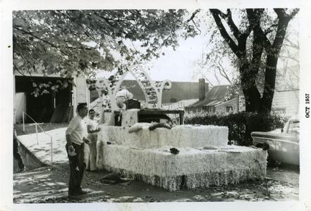 Sigma Tau Gamma members working on homecoming float, out of Carriage House