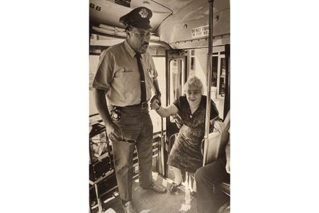 Bus driver offers his hand to an elderly passenger boarding the bus in Milwaukee, Wisconsin