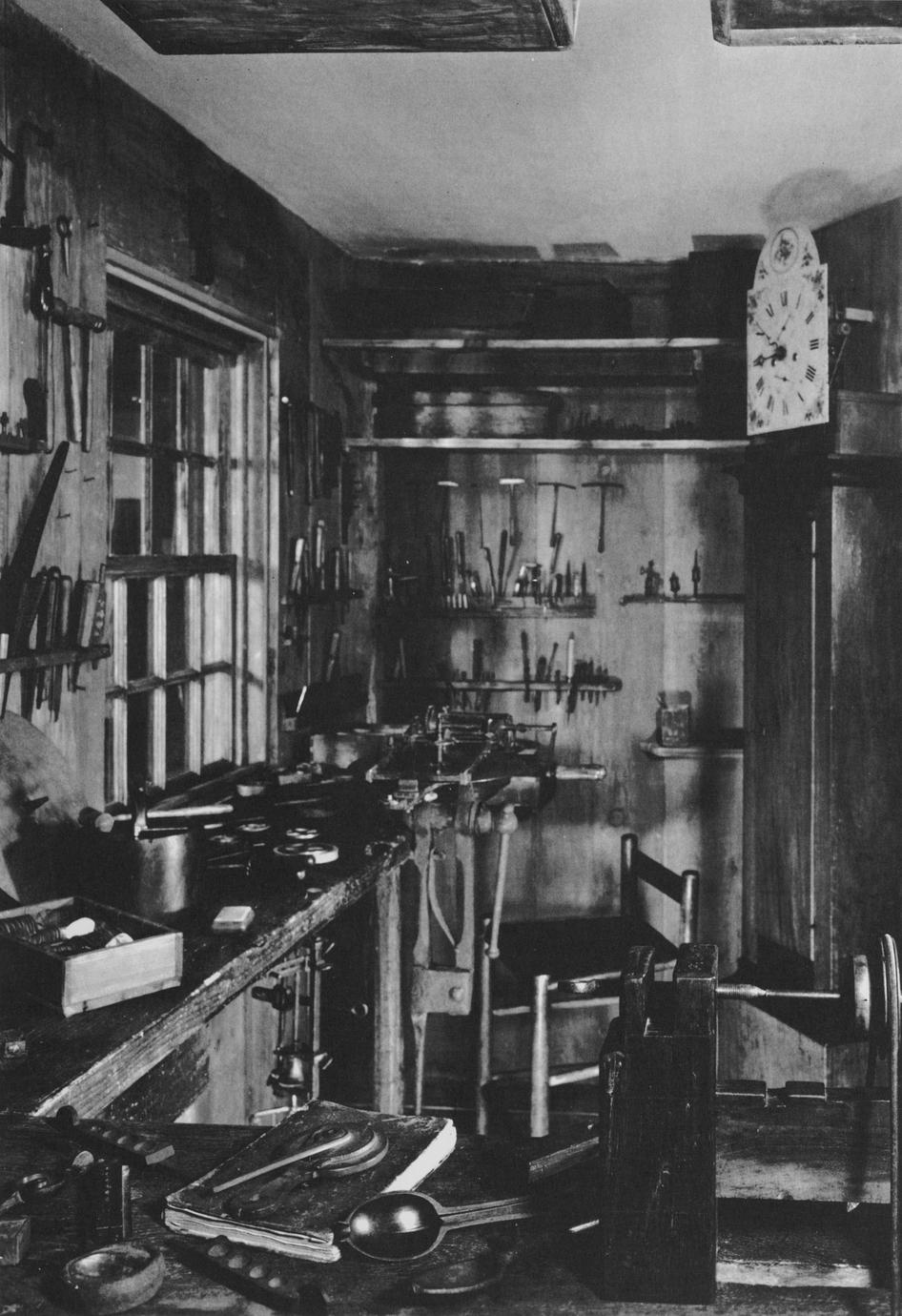 Black and white photograph of the interior of the reconstructed Dominy clock shop