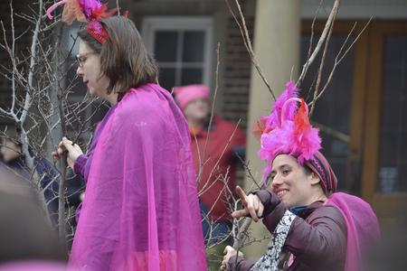 Two people in pink feather hats