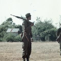 Local soldier stands on airstrip at Houei Kong in Attapu Province