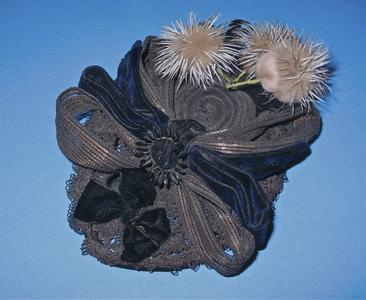 Black bonnet with wire daisies