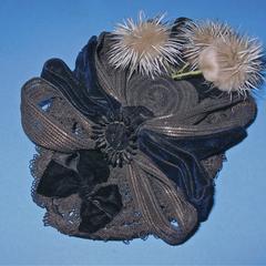 Black bonnet with wire daisies