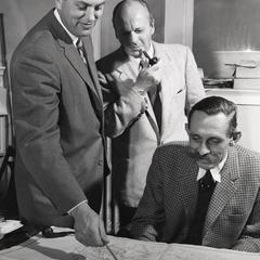 Professors examine meteorological maps