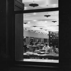 Students studying seen through a window