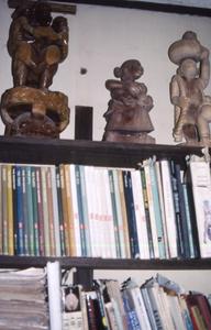 Sculptures above bookshelf