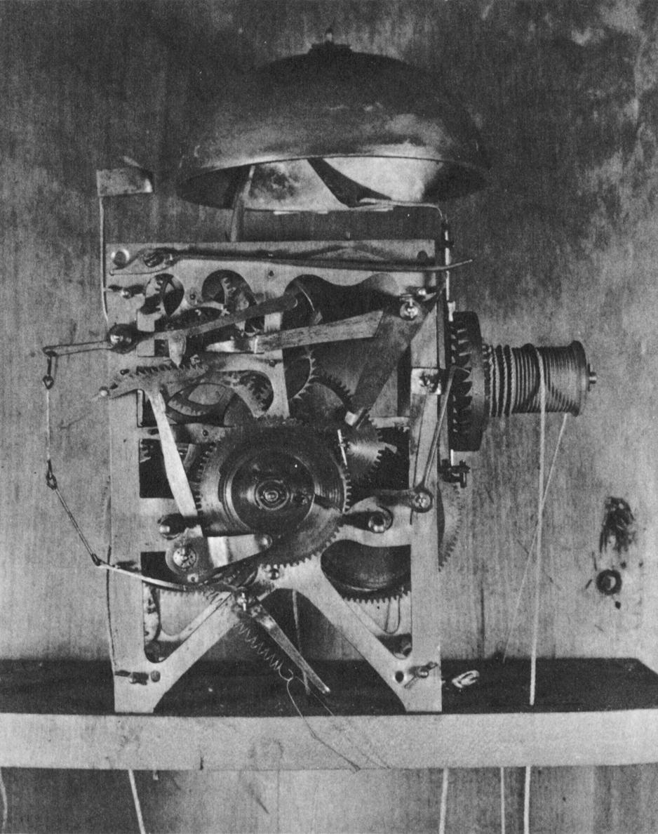 Black and white photograph of a gear system from an eight-day, strike, repeater, alarm clock.