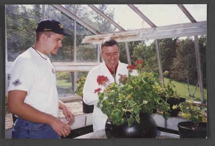 Professor Sami Saad (Biology) and student in greenhouse