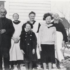 Dantoin family and neighbors behind their home in Casco