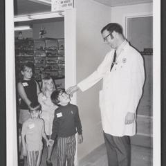 Hospital pharmacist greets a group of children in children's hospital
