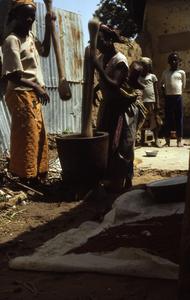 Village women pounding food