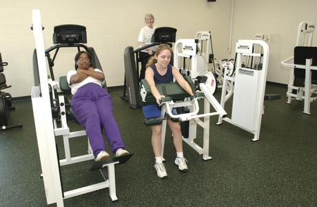 Female students utilize the weight room