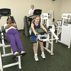 Female students utilize the weight room