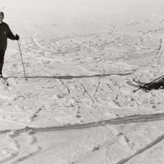 Student sitting in snow during ski class