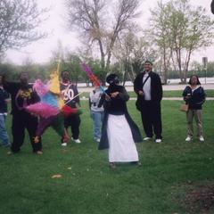 Woman swings at a pinata during the 2002 multicultural picnic