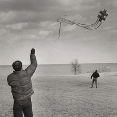 Kite flying on campus lawn, Manitowoc, March 1969